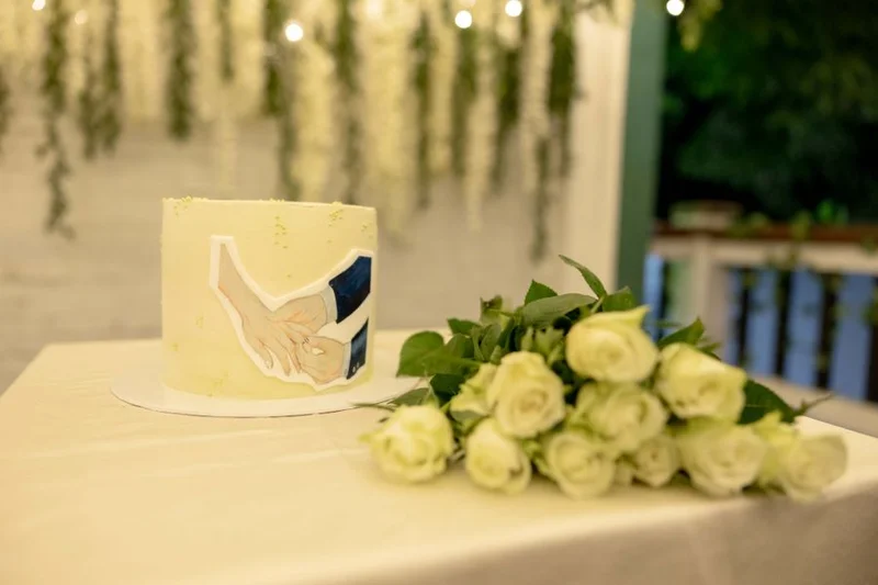 A wedding cake decorated with white roses